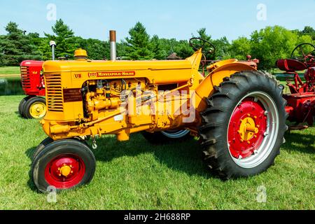 A antique yellow 1953 Minneapolis Moline UB row crop farm tractor on display at a tractor show in Warren, Indiana, USA. Stock Photo