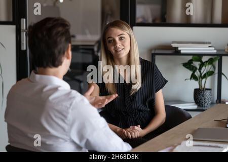 Happy two colleagues briefing new project ideas. Stock Photo