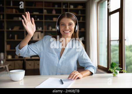 Smiling attractive young woman starting video call. Stock Photo