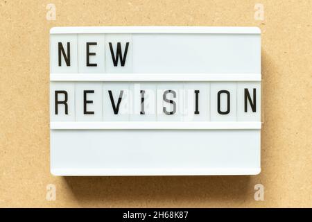 Lightbox with word new revision on wood background Stock Photo