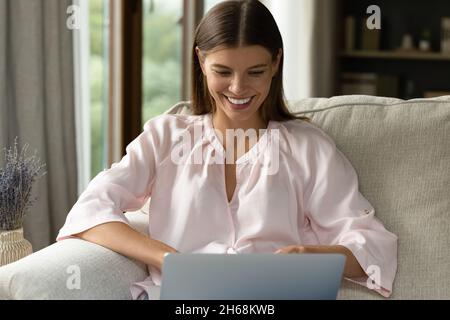 Happy beautiful young woman working on computer. Stock Photo