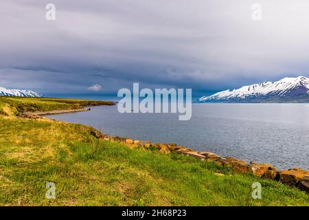 Looking out to sea over the Eyjafjordur at Hauganes in north Iceland Stock Photo