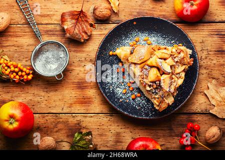 Autumn pie with apples, nuts and sea buckthorn. Charlotte on kefir. Stock Photo
