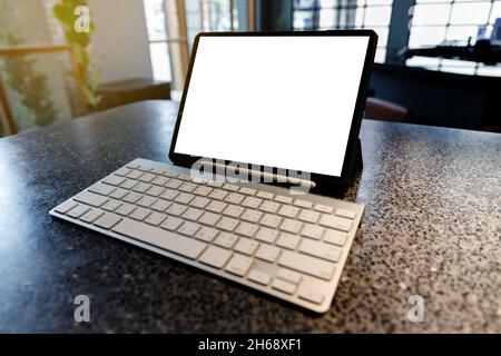 tablet with empty white screen in cafe tablet blank screen browsing internet or connecting Stock Photo