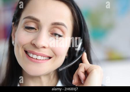 Woman in headset working in a call center, face close-up Stock Photo