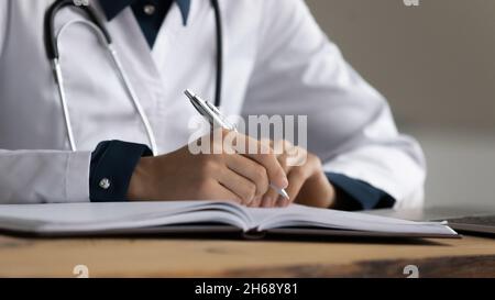 Close up cropped of female doctor therapist taking notes Stock Photo