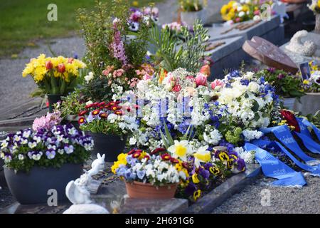 Tombs lavishly decorated with flowers Stock Photo