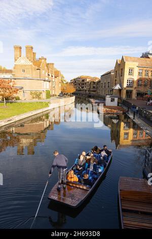 Cambridge UK; Punting on the River Cam at Magdalene Bridge in the city centre in autumn, Cambridge England UK Stock Photo