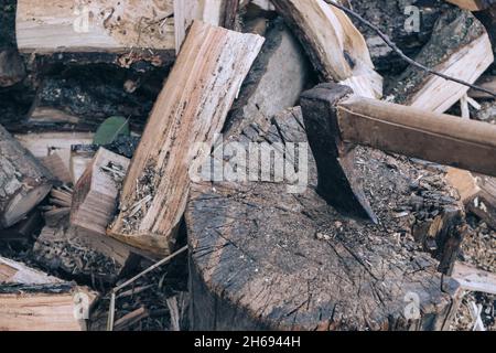 The ax lies on the wood. Firewood chopping. Preparation of firewood for the winter. Iron ax with wooden handle Stock Photo