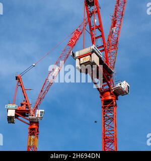 Victoria Westminster London England UK, November 7 2021, Two Tall Red Tower Cranes Against A Blue Sky With No People Stock Photo