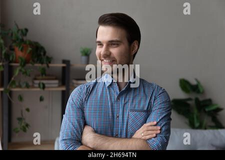 Head shot handsome young man standing with folded arms. Stock Photo