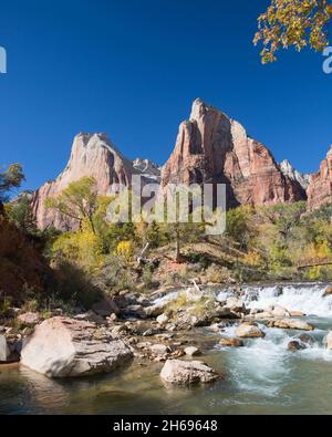 Zion National Park, Utah, USA. View across the Virgin River to Abraham and Isaac, neighbouring rock formations in the Court of the Patriarchs, autumn. Stock Photo