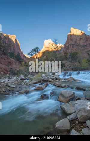 Zion National Park, Utah, USA. View at sunrise across the Virgin River to Abraham and Isaac, rock formations in the Court of the Patriarchs, autumn. Stock Photo