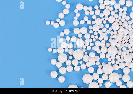 White round polystyrene snow balls on blue background with copy space Stock Photo