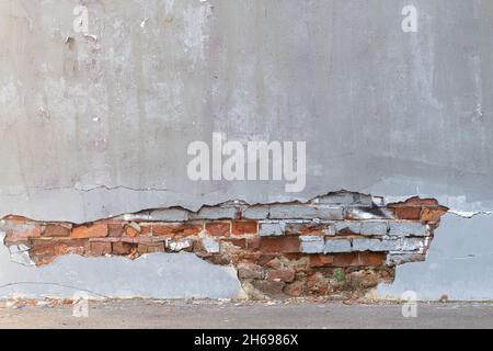 Part of a building wall with fallen off plaster and exposed brickwork. Reference material for artists. Stock Photo