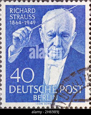 GERMANY, Berlin - CIRCA 1954: a postage stamp from Germany, Berlin showing a portrait of Richard Strauss with baton. Occasion: 5th anniversary of Rich Stock Photo