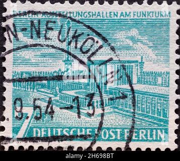 GERMANY, Berlin - CIRCA 1954: a postage stamp from Germany, Berlin showing Berlin buildings:Exhibition halls at the radio tower. Green Blue Stock Photo