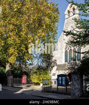 The church, St Mary the Boltons, in the Boltons, Kensington, London; a church inside a locked private communal garden; the residents around the garden. Stock Photo