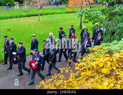 Bournemouth, Dorset UK. 14th November 2021. Remembrance Sunday Parade and wreath laying service - representatives of armed services, forces groups and cadets parade through Bournemouth gardens followed by a service and wreath laying at the War Memorial in Central Gardens. Crowds gather to pay their respects and remember the fallen on a mild day. This year coincides with the centenary year of the Royal British Legion. Veterans march through the garden. Credit: Carolyn Jenkins/Alamy Live News Stock Photo