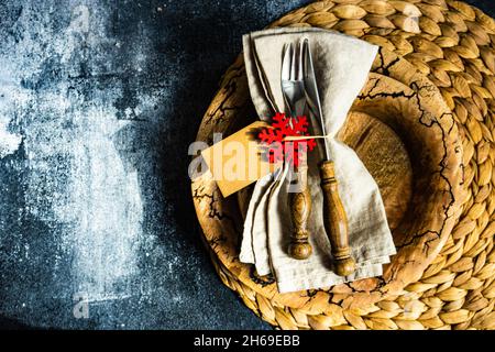 Festive place setting for holiday Christmas dinner on concrete table Stock Photo
