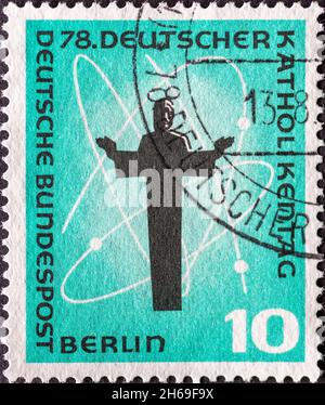 GERMANY - CIRCA 1958: a postage stamp from Germany, Berlin showing a representation of Christ, cosmos symbol. 78th German Catholic Day in Berlin Stock Photo