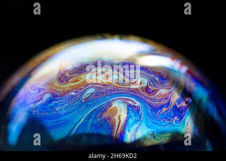 Abstract pattern, multicolored chaotic texture inside of the soap bubble, closeup Stock Photo