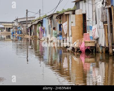 November 12, 2021, Tangerang Regency, Banten, Indonesia: Local folk activity when the area being flooded. Not only the Capital City of Jakarta which on threats of being drowned in the upcoming year, threat of abrasion is crawling on the feet of North Banten Coastal Area which located exactly on Dadap Village, Kosambi Disctrict, Tangerang Regency. Local folks who live on that area have to live side by side with high tide level which frequently saturate their settlement. This phenomenon occurs because of land subsidence. Datas from National Development Planning Agency (BAPPENAS) on 2020 stated t Stock Photo