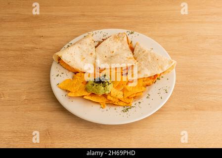 https://l450v.alamy.com/450v/2h69phd/a-corn-or-wheat-tortilla-folded-in-half-that-can-be-filled-with-cheese-beans-and-chicken-and-eaten-hot-either-fried-or-cooked-on-the-comal-with-cor-2h69phd.jpg