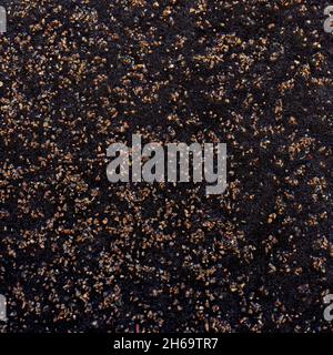 Dark grunge texture with small light pebbles Stock Photo
