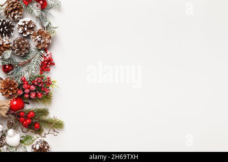 Christmas winter concepts. Fir branches with cones on a gray background. Borders flat lay top view copy space Stock Photo