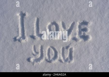 Text I love you on a white fresh snow in winter, close up. Drawings of the words I love you in the winter season Stock Photo