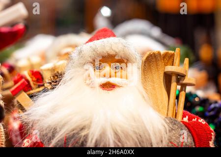 Bright colorful Santa Claus doll in red costume with long white beard. Christmas and New Year holidays traditional decorations concept. Stock Photo