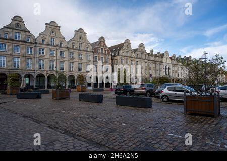 Arras, France - November 4, 2021: Town square of Arras, France. UNESCO World Heritage Site. House facades in Flemish style against a dark grey sky Stock Photo