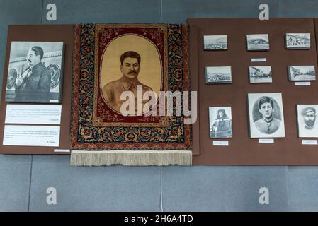 Historical photographs and a rug on display in the Joseph Stalin museum in Gori,  Shida Kartli, Georgia, Caucasus Stock Photo