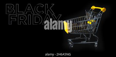Small shopping cart with black background with text black friday Stock Photo