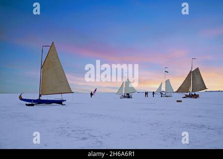 Ice sailing on the Gouwzee in winter in the Netherlands at sunset Stock Photo