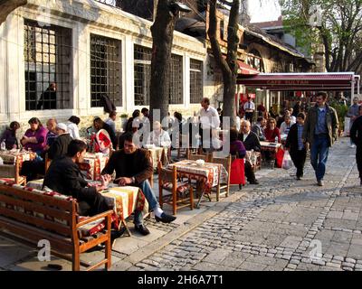 Turkish people enjoying tee and coffee in leisure time at a street cafe, in Sultan Ahmet square, in Istanbul, Turkey, Asia. Stock Photo
