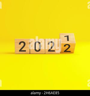 Flip over wooden cube block with new year 2022 on yellow background. 3D illustration.