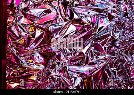 Modern beautiful holographic wrinkled foil background Stock Photo