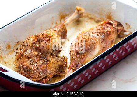 baked goose legs with cumin in frying pan Stock Photo