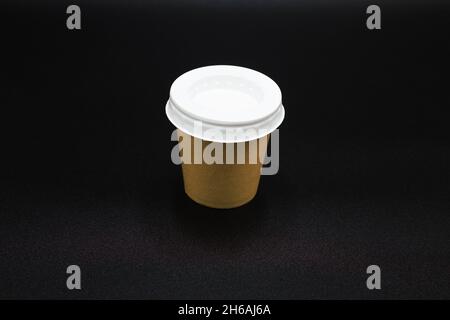 Side view of a coffee to go cup with a black background . Stock Photo