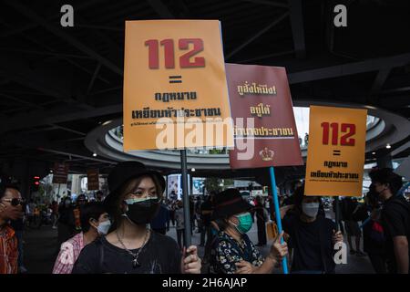 Bangkok, Thailand. 14th Nov, 2021. Protesters hold placards during the demonstration.Pro-democracy protesters gathered at Pathumwan Intersection for a “Fighting Against the Absolute Monarchy” campaign. This campaign came after a verdict of the Constitutional Court, Judged that three “reformation of the monarchy” speeches on 10 August 2020 is “annihilate the constitutional monarchy”. The protesters demand for monarchy reformation and abolition of a criminal law section 112 (Lèse-majesté). Credit: SOPA Images Limited/Alamy Live News Stock Photo