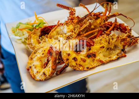 Closeup of freshly grilled lobster tails served with vegetables salad and rise. High quality photo Stock Photo