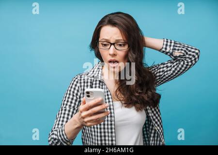 Upset woman who found out the bad news. Loss of finances, bankruptcy of a business, a fall in the exchange rate of securities. The brunette looks at Stock Photo