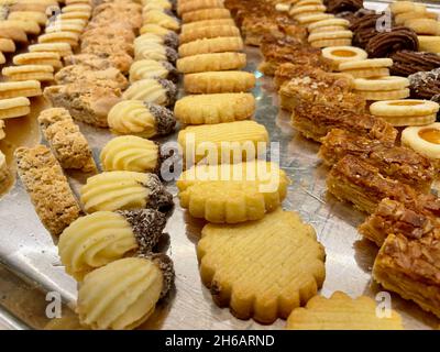 Assorted Christmas cookies in rows on silver tray. Stock Photo