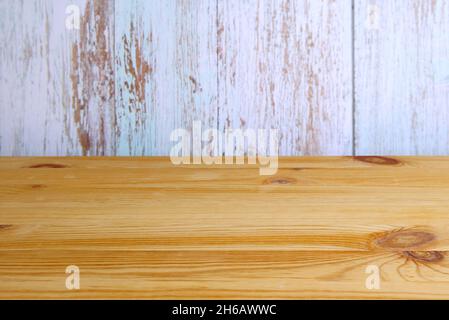Empty wooden table top with blurry grunge painted wall in the backdrop Stock Photo