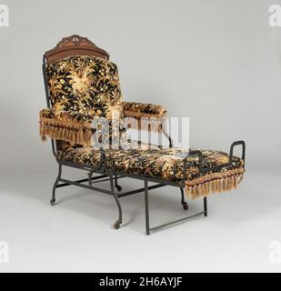 Chair, 1876. Folding chair with fringe decoration, used as an invalid chair, a smoking chair, or a bed. Stock Photo