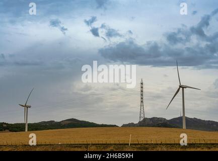 Electrical energy in nature. Clean energy concept. Wind energy and high voltage towers. Stock Photo