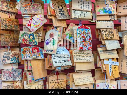 tokyo, japan - september 17 2019: Shinto timber votive plaques called Ema illustrated by worshippers with illustrations of tv anime characters in the Stock Photo
