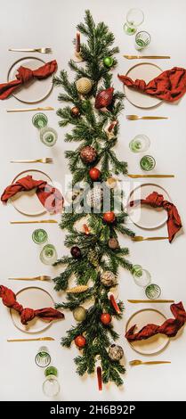 Flat-lay of festive Christmas table setting with decorations, vertical composition Stock Photo